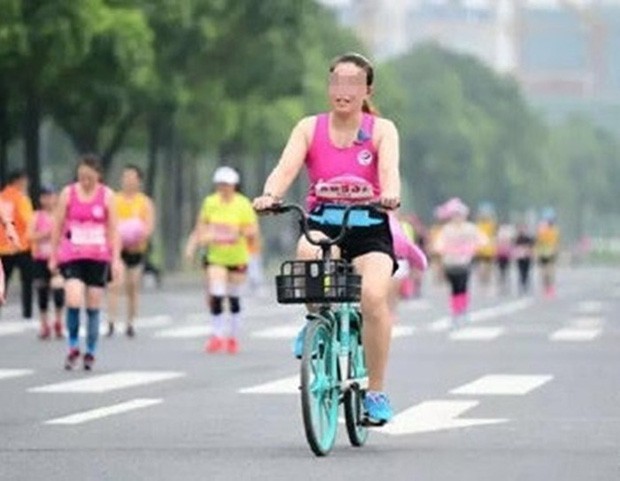 Thản nhiên phi xe đạp giữa cuộc thi chạy, lại còn tự sướng khi bị chụp ảnh, hai nữ VĐV nhận về cái kết đắng - Ảnh 1.